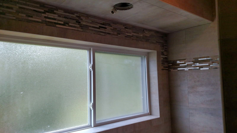 Bathroom window framed in glass mosaic tile in Coeur d'Alene, Idaho