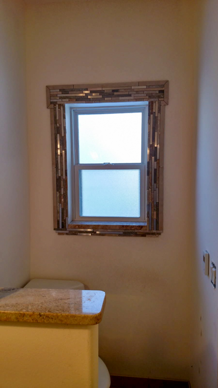 Powder room with mosaic-framed window in Dalton Gardens, Idaho