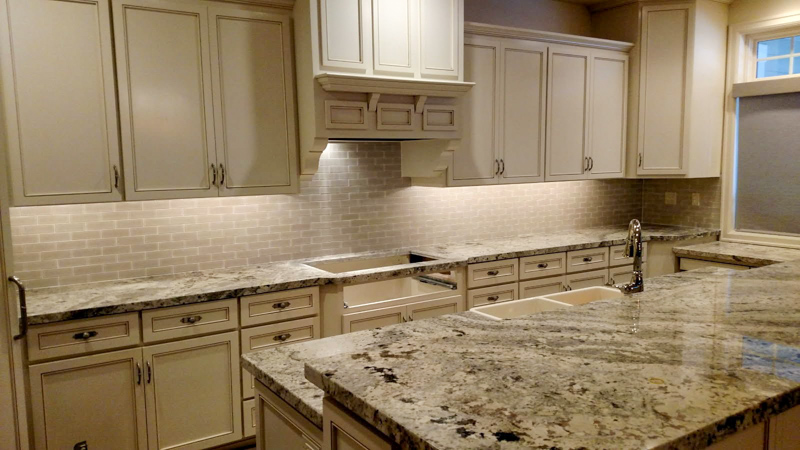 White cabinet kitchen with granite countertops in Post Falls, Idaho