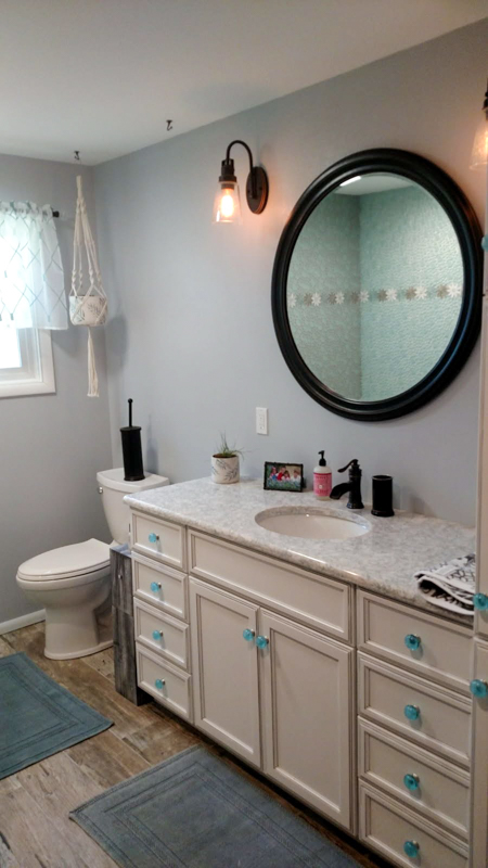 Cream vanity with round mirror bathroom in Rathdrum, Idaho