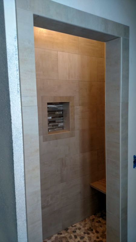 Walk-in shower with inset niche and bench in Hayden, Idaho